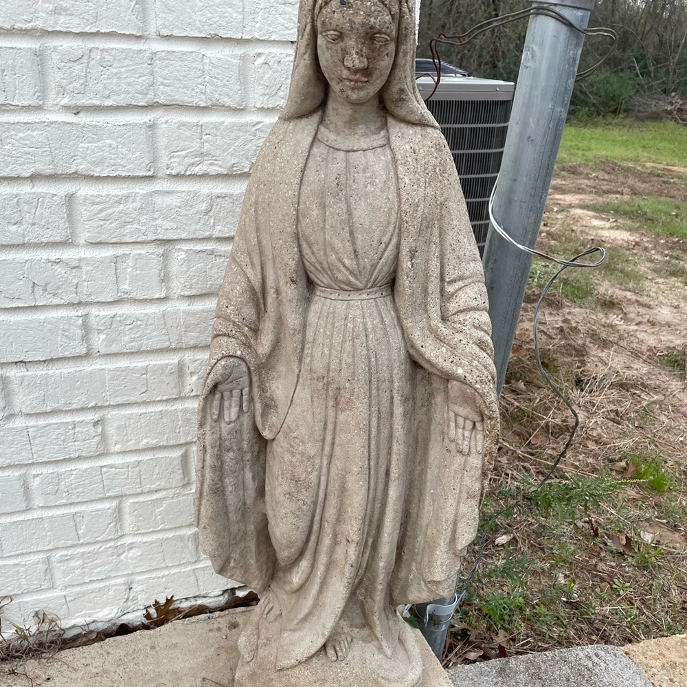 The statue is a woman standing on a snake, the woman resembling protection.